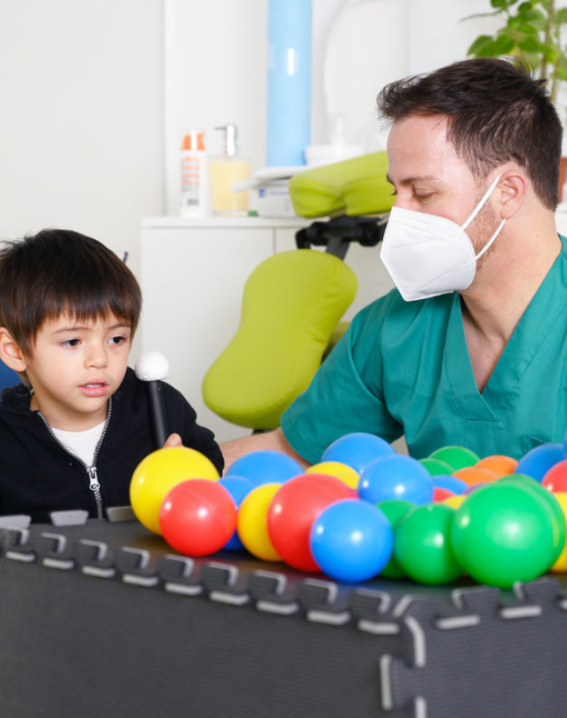 Therapist with child and colorful balls
